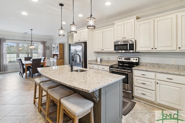 4 Honeysuckle Dr, Claxton, GA 30417 - kitchen featuring stainless steel appliances, crown molding, light tile patterned floors, recessed lighting, and an island with sink