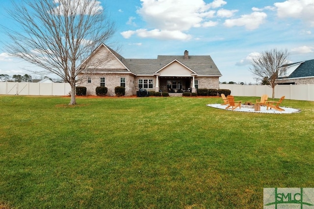 4 Honeysuckle Dr, Claxton, GA 30417 - rear view of house with an outdoor fire pit, a patio area, a fenced backyard, and a chimney