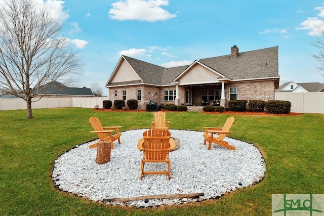 4 Honeysuckle Dr, Claxton, GA 30417 - back of house with an outdoor fire pit, a chimney, brick siding, a patio area, and a shingled roof
