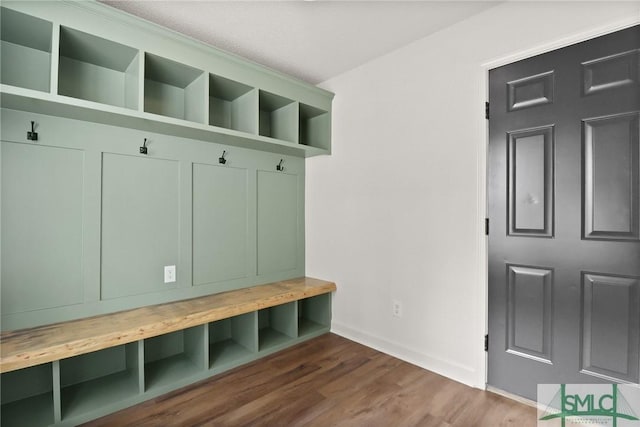 mudroom with baseboards, wood finished floors, and a textured ceiling