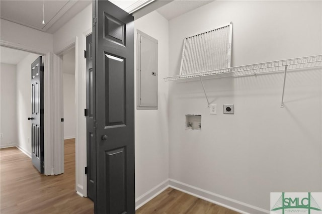 washroom with washer hookup, electric panel, hookup for an electric dryer, wood finished floors, and attic access