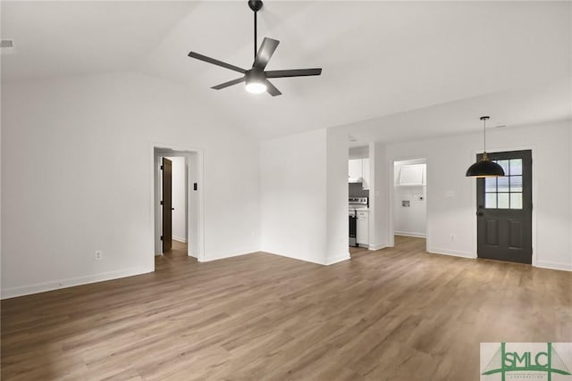 unfurnished living room featuring a ceiling fan, light wood-type flooring, lofted ceiling, and baseboards