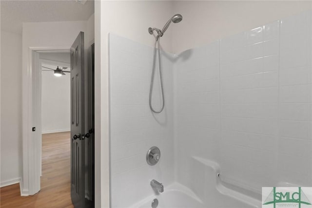 full bath with wood finished floors and shower / tub combination
