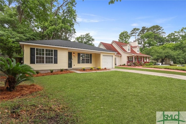 view of front of home featuring an attached garage, driveway, and a front lawn