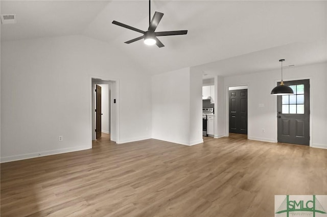 unfurnished living room with a ceiling fan, light wood-type flooring, vaulted ceiling, and baseboards