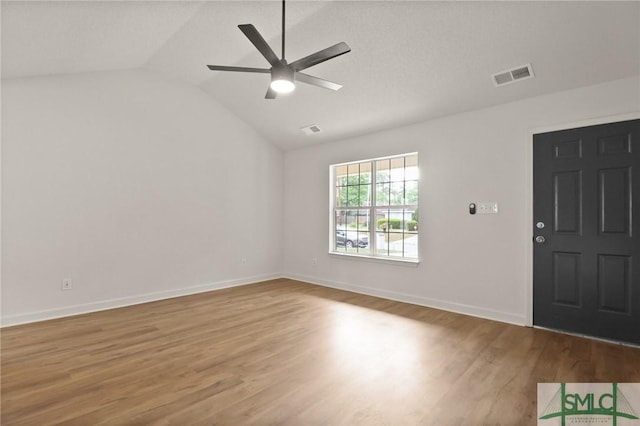 entrance foyer featuring vaulted ceiling, wood finished floors, a ceiling fan, and baseboards
