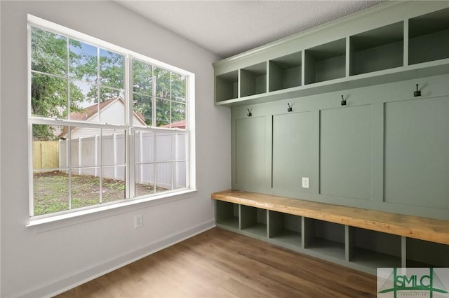 mudroom with baseboards, wood finished floors, and a textured ceiling
