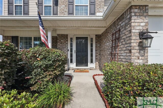 309 Nashview Trl, Allenhurst, GA 31301 - doorway to property featuring a porch and brick siding