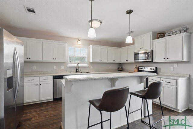 309 Nashview Trl, Allenhurst, GA 31301 - kitchen with appliances with stainless steel finishes, dark wood finished floors, a sink, white cabinetry, and light countertops