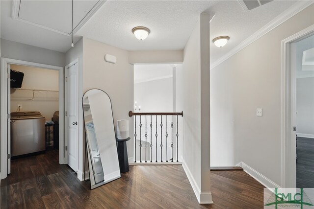 309 Nashview Trl, Allenhurst, GA 31301 - hallway featuring washer / dryer, attic access, wood finished floors, baseboards, and an upstairs landing