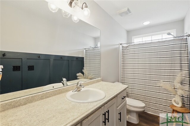 309 Nashview Trl, Allenhurst, GA 31301 - full bathroom featuring wood finished floors, toilet, vanity, and a shower with curtain