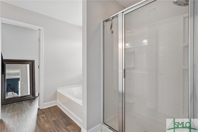 309 Nashview Trl, Allenhurst, GA 31301 - full bathroom with a stall shower, wood finished floors, a garden tub, and baseboards