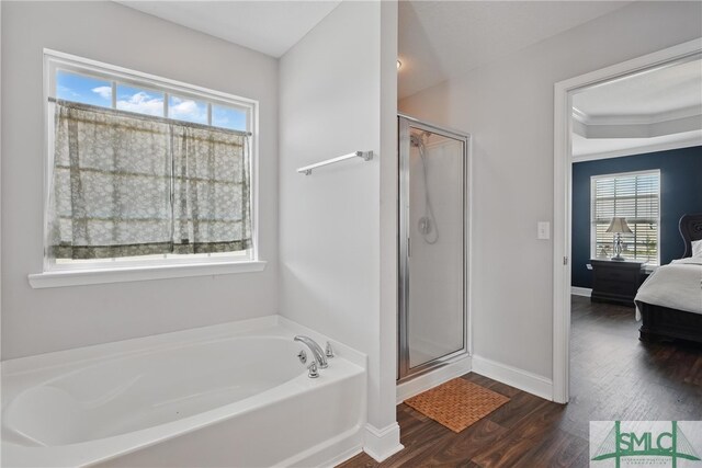 309 Nashview Trl, Allenhurst, GA 31301 - ensuite bathroom featuring healthy amount of natural light, wood finished floors, a bath, and a shower stall