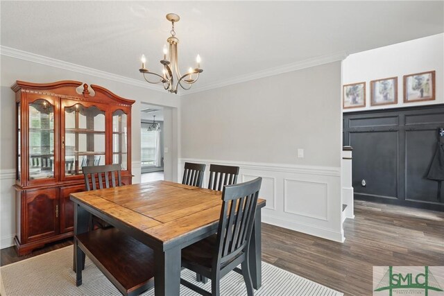 309 Nashview Trl, Allenhurst, GA 31301 - dining space featuring a decorative wall, a chandelier, ornamental molding, dark wood-style flooring, and a wainscoted wall