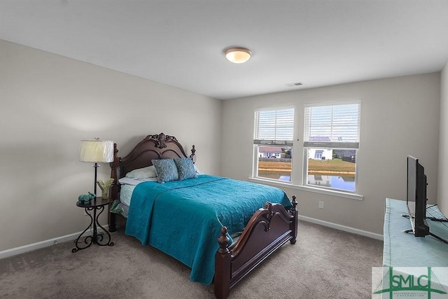 carpeted bedroom featuring baseboards