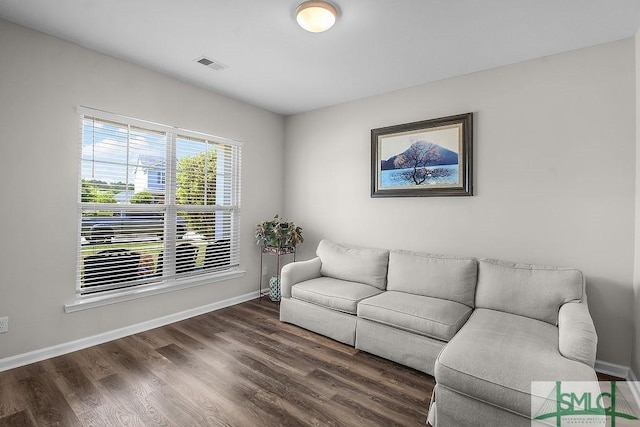 living room with wood finished floors and baseboards