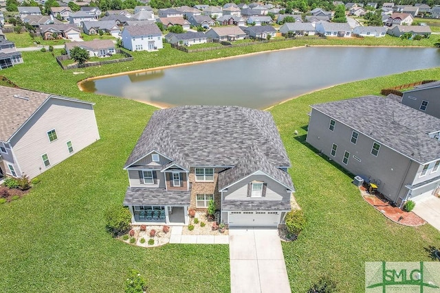 aerial view of residential area featuring a large body of water