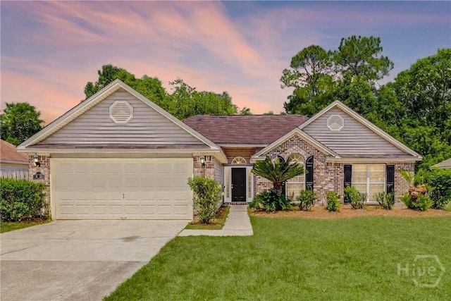 233 Jasper Ln, Rincon, GA 31326 - ranch-style house featuring concrete driveway, a yard, an attached garage, and brick siding