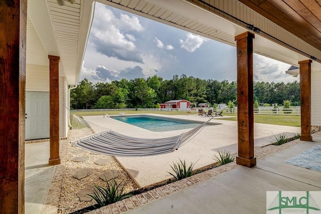 1840 Mccall Rd, Rincon, GA 31326 - outdoor pool with a patio, fence, an outbuilding, and a storage unit
