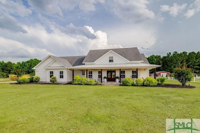 1840 Mccall Rd, Rincon, GA 31326 - view of front of property with board and batten siding, covered porch, a front lawn, and roof with shingles