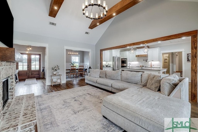 1840 Mccall Rd, Rincon, GA 31326 - living room featuring a chandelier, dark wood-type flooring, beamed ceiling, high vaulted ceiling, and a fireplace