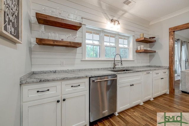 1840 Mccall Rd, Rincon, GA 31326 - kitchen with stainless steel dishwasher, a sink, open shelves, wood finished floors, and white cabinets