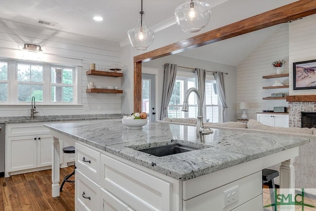 1840 Mccall Rd, Rincon, GA 31326 - kitchen featuring plenty of natural light, a sink, wooden walls, vaulted ceiling, and dark wood finished floors