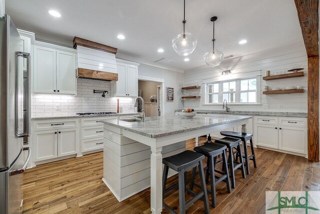 1840 Mccall Rd, Rincon, GA 31326 - kitchen with open shelves, freestanding refrigerator, a sink, custom range hood, and tasteful backsplash