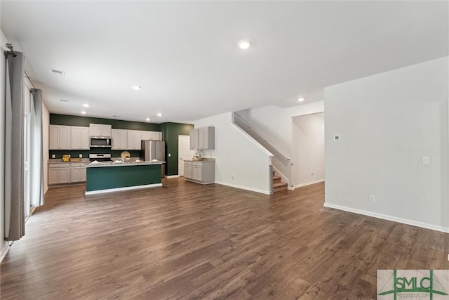 238 Sage Field Dr, Rincon, GA 31326 - unfurnished living room with dark wood-style floors, baseboards, recessed lighting, and stairway