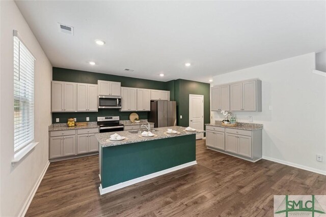 238 Sage Field Dr, Rincon, GA 31326 - kitchen featuring appliances with stainless steel finishes, dark wood-style flooring, an island with sink, baseboards, and recessed lighting