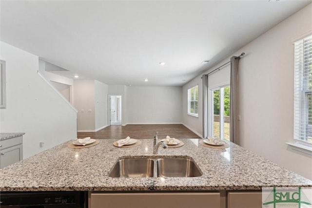 238 Sage Field Dr, Rincon, GA 31326 - kitchen with a sink, open floor plan, light stone counters, black dishwasher, and an island with sink