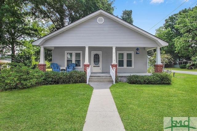 8 Georgia St, Pembroke, GA 31321 - view of front of house with a front lawn and a porch