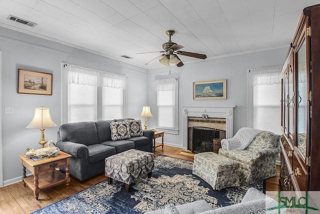 8 Georgia St, Pembroke, GA 31321 - living room with ornamental molding, a ceiling fan, wood finished floors, a fireplace with flush hearth, and baseboards