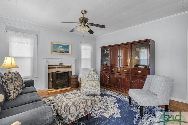 8 Georgia St, Pembroke, GA 31321 - living area featuring a ceiling fan, wood finished floors, ornamental molding, a fireplace, and baseboards