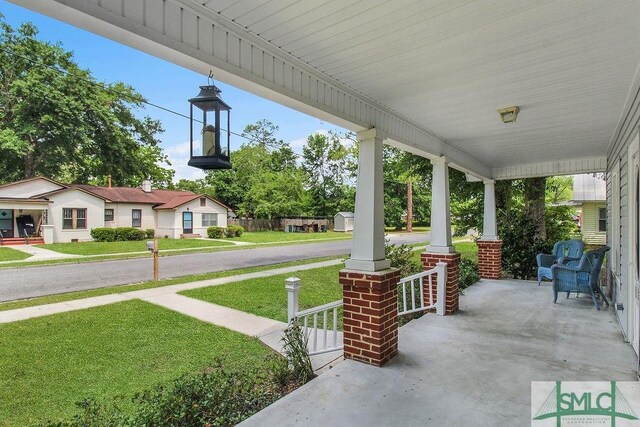 8 Georgia St, Pembroke, GA 31321 - covered porch with a lawn