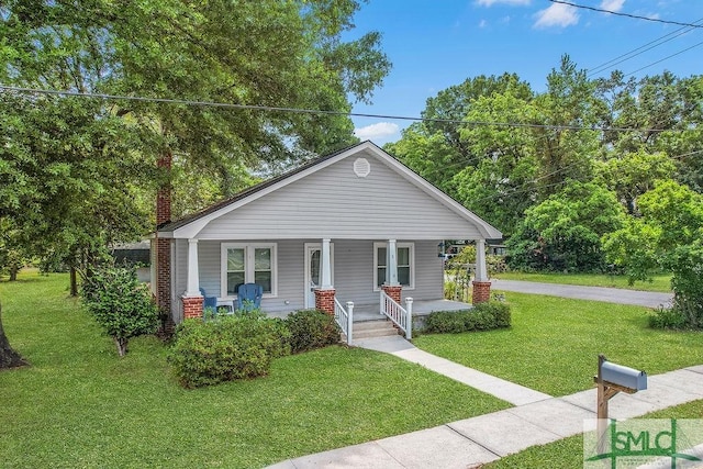 8 Georgia St, Pembroke, GA 31321 - bungalow with covered porch, a front lawn, and a chimney