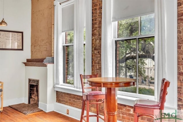 20 W Oglethorpe Ave Unit D, Savannah, GA 31401 - dining area with wood finished floors, a fireplace with raised hearth, and baseboards