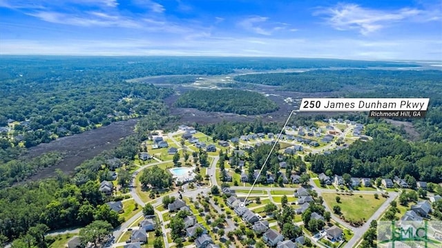 250 James Dunham Pkwy, Richmond Hill, GA 31324 - aerial view of property and surrounding area featuring nearby suburban area and a forest
