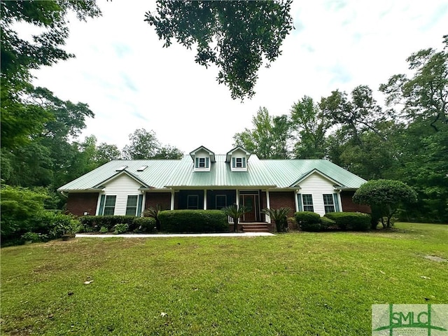 view of front facade featuring a front lawn, covered porch, and brick siding