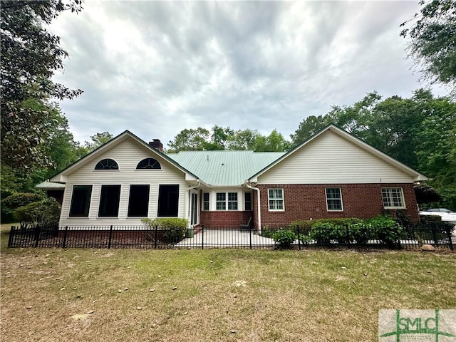 rear view of property with brick siding, a chimney, and a patio