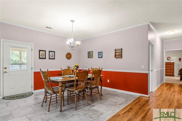 330 Central Ave, Guyton, GA 31312 - dining area with crown molding, a chandelier, baseboards, and a textured ceiling