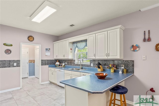 330 Central Ave, Guyton, GA 31312 - kitchen with a sink, dishwasher, dark countertops, a kitchen breakfast bar, and backsplash