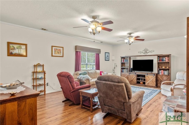 330 Central Ave, Guyton, GA 31312 - living room with ceiling fan, light wood finished floors, ornamental molding, and a textured ceiling