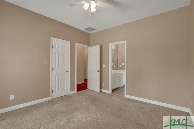 unfurnished bedroom with carpet floors, baseboards, ensuite bathroom, and a ceiling fan