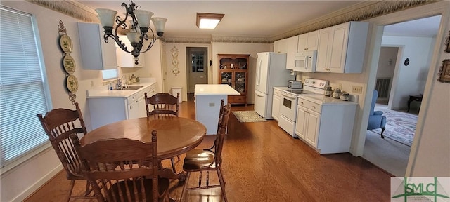 131 Farringdon Cir, Savannah, GA 31410 - kitchen with white appliances, a chandelier, light countertops, ornamental molding, and dark wood-type flooring