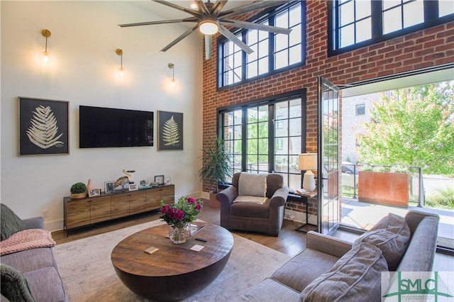 456 Port St, Savannah, GA 31401 - living area with wood finished floors, a ceiling fan, plenty of natural light, and a towering ceiling