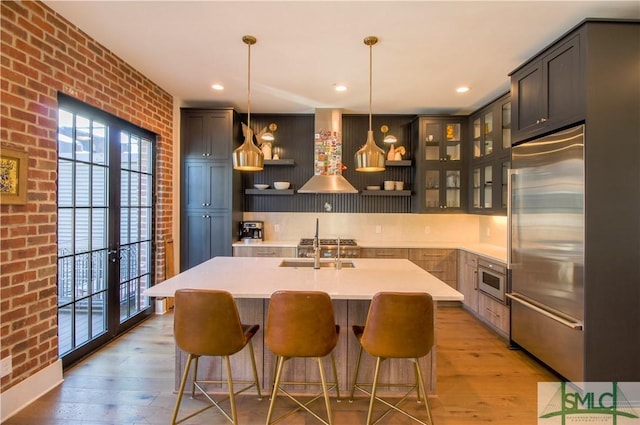 456 Port St, Savannah, GA 31401 - kitchen featuring built in refrigerator, brick wall, plenty of natural light, light wood-type flooring, and recessed lighting
