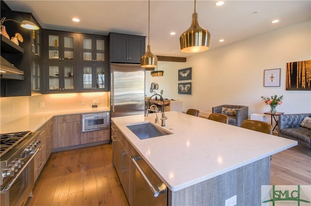 456 Port St, Savannah, GA 31401 - kitchen with stainless steel appliances, a sink, hardwood / wood-style floors, recessed lighting, and a center island with sink