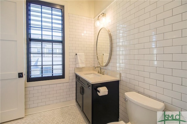 456 Port St, Savannah, GA 31401 - bathroom featuring tile walls, vanity, toilet, and tile patterned flooring