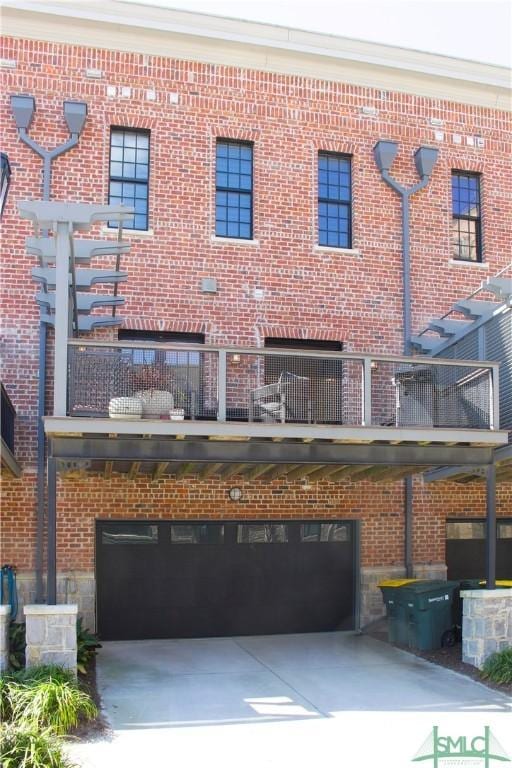 456 Port St, Savannah, GA 31401 - rear view of house with a garage, a balcony, and concrete driveway